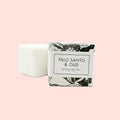 Bar of soap with packaging labeled 'Palo Santo & Oud' on a white background