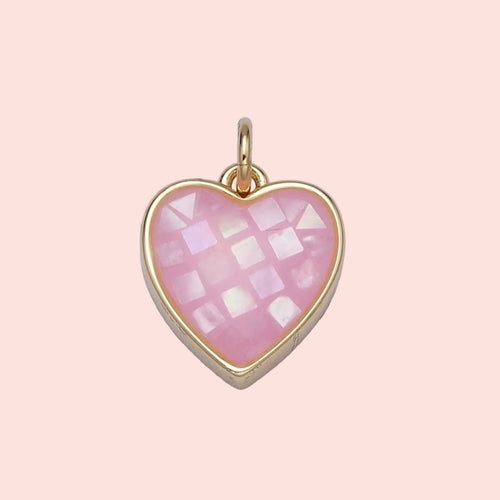 Heart-shaped pendant with pink checkered design and gold frame on a light gray background