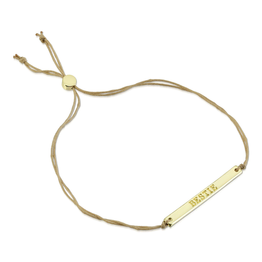 Gold bracelet with a nameplate on a white background