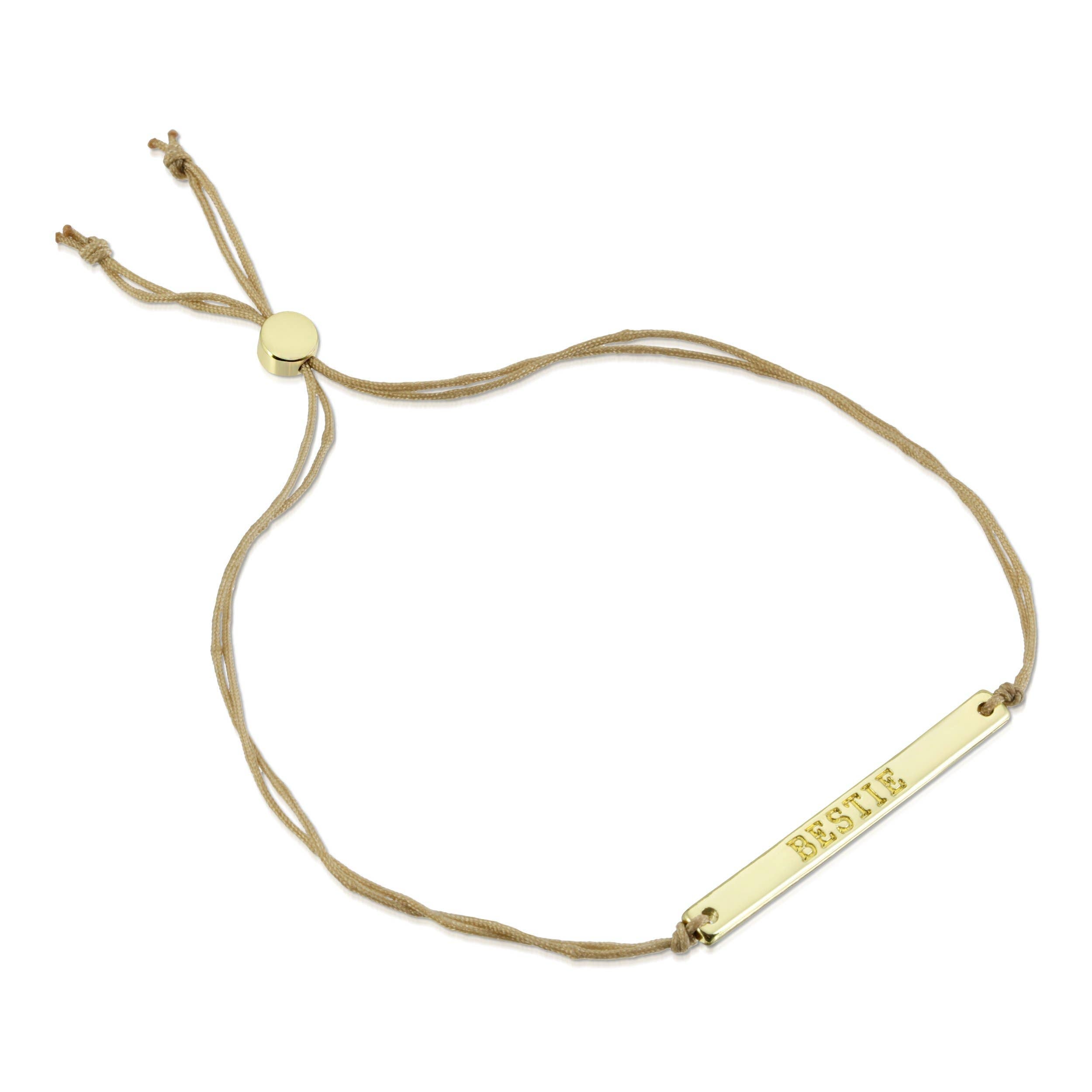 Gold bracelet with a nameplate on a white background
