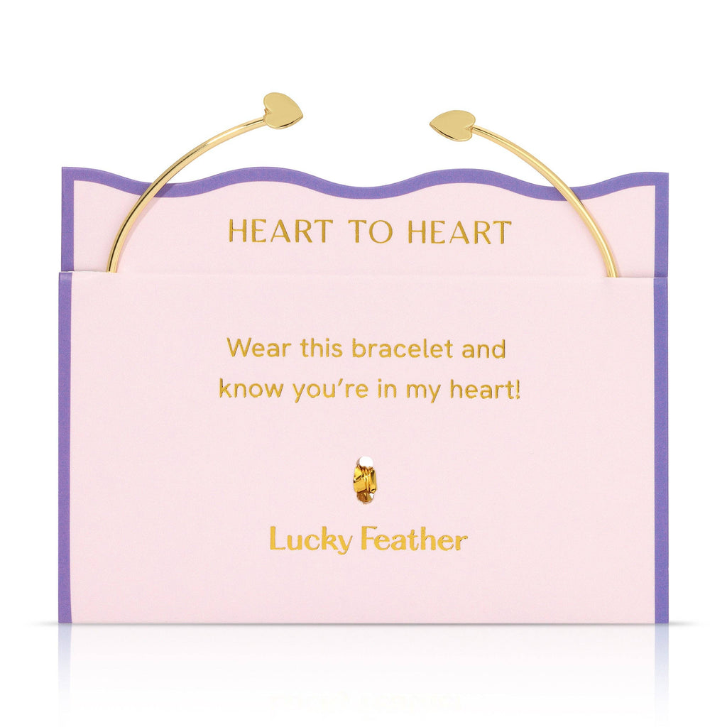 Bracelet packaging with 'Heart to Heart' message and 'Lucky Feather' branding.