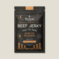 Packaging of Rogue Beef Jerky with 'Bonfire Bourbon' flavor on a beige background